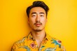 © Anastasiia - Symmetrical, Confident Asian Man Poses Against Vibrant Yellow Background With Copy Space