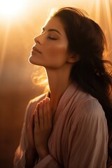 Wall Mural - A woman is pictured with her eyes closed in prayer. This image can be used to depict spirituality, meditation, or personal reflection