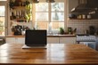 A laptop sitting on a wooden countertop in a modern kitchen Generative AI