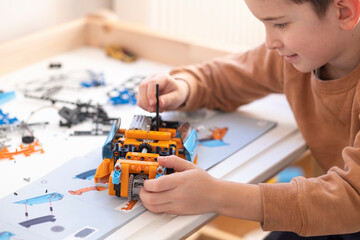 A little boy plays with blocks. Educational fun for children.