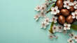 Dyed eggs Easter cherry flowers banner background copy space. Springtime festive. Eastertime floral image backdrop mint blue. Spring theme concept composition top view, copyspace