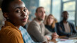 © Ed - Portrait of a young African American businesswoman at a meeting in the office, discussion before making decisions in an international company