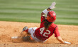 © Shop Road Images - An American softball player slides into base during game action.
