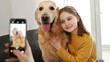 © Ievgen Skrypko - Girl hand with smartphone taking photo of golden retriever dog and preteen child kid at home. Woman mother photograph shoting pet doggy and daughter with mobile phone camera