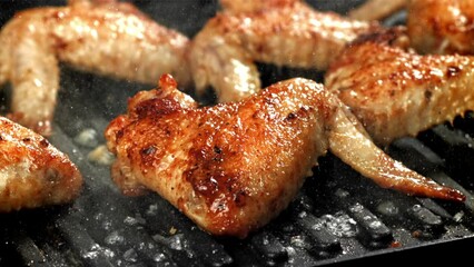 Canvas Print - Chicken wings are fried in a pan. Filmed on a high-speed camera at 1000 fps. High quality FullHD footage