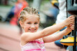 © Ievgen Skrypko - Portrait of Happy smiling little girl playing at the playground and climb the ropes outdoor