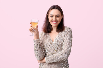 Poster - Beautiful young woman with glass of white wine on pink background