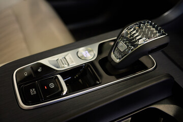 Wall Mural - Selector automatic transmission with leather in the interior of a modern expensive car. The background is blurred. Black and brown leather car.