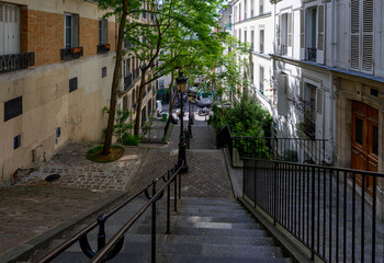 Wall Mural - Typical street in Montmartre with staircase in Paris, France. Cozy cityscape of Paris. Architecture and landmarks of Paris.