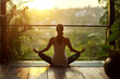 © Kate Mayer - Woman doing yoga asana with closed eyes on beautiful tropical terrace. Mental balance and wellness concept