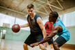 © Marko Geber - Basketball players playing basketball in an indoor basketball gym