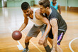 © Marko Geber - Young people playing basketball in an indoor basketball gym