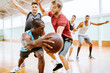 © Marko Geber - Diverse group of young men playing basketball in an indoor basketball gym