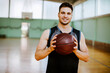© Marko Geber - Portrait of a young male basketball player in an indoor basketball gym
