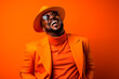 © Lucas - Artistic portrait of a stylish African-American man laughing on an orange background, vibrant colors. Generative AI