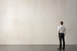© O-Foto - businessman standing in front of a wall