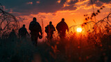 Figures trek along the barbed wire fence at dawn, their journey highlighted by the morning sun.