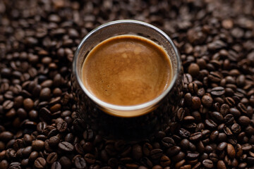 Coffee cup and coffee beans on a dark background. Close up.