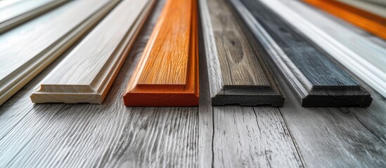 Various colored plastic skirting board resembling wood texture, designed and produced for interior design of living spaces.
