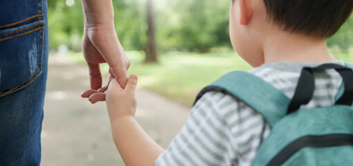 Asian Mother and son holding hands walking