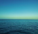 Fototapeta  - Calm oceanic gradient from deep blue to seafoam green