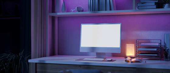 Wall Mural - A modern home office workspace with a computer and a dim light from a table lamp on a table.