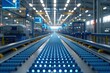 Modern industrial factory with automated machinery and conveyor belts for manufacturing and transportation. Blue steel machinery and equipment in empty warehouse modern production technology