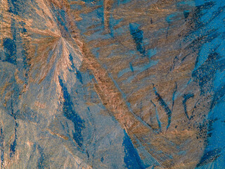 Wall Mural - Beautiful ice pattern and sunlight close up on window glass early in the morning, natural winter background  