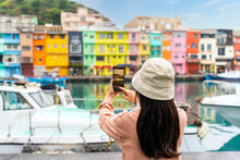Young Female Traveler Taking A Photo Of Colorful Zhengbin Fishing Port Landmark And Popular Attractions In Taiwan