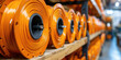 © Planetz - a spool of orange cables optic on a wooden rack,