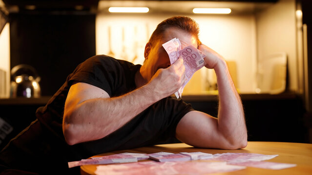 Wealthy man crying and wipe tears with stack of money banknotes meme sarcasm