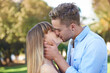 Couple, kiss in park and love outdoor for healthy relationship, commitment and tender moment together in nature. Loyalty, respect and trust, people on a romantic date and bonding in public garden