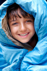 Wall Mural - Boy, child and tent portrait for camping, relax and happy summer vacation in outdoor travel. Young camper, smile and wrapped in sleeping bag, adventure or nature with recreation for childhood