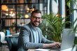 © Kien - Attractive cheerful business man working on laptop at modern office
