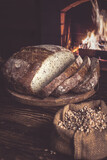 Fototapeta Na sufit - Homemade bread on the background of a home hearth