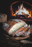 Fototapeta Na sufit - Homemade bread on the background of a home hearth