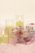 Candles, dessert and gift boxes on delicate pink fabric. Poster for interior. Romantic mood in the form of candles and gifts.