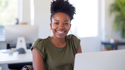 Sticker - Young woman is focused on working on her laptop in a modern office