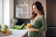 © lenblr - Portrait of fit pregnant woman drinking healthy smoothie. Smiling woman shows balance between fitness and well-being during pregnancy