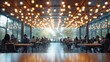 © AdriFerrer - Busy modern cafeteria with round lights and people engaged in discussion.