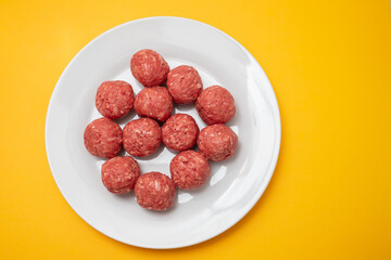 Wall Mural - Top view of raw meat balls on small plate