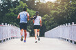 Couple running together on road across the bridge. Couple, fit runners fitness runners during outdoor workout