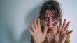 I'm afraid. Portrait of a frightened scared young woman with a bruise or abrasion on the face, on a white background in a begging pose extends arms forward in defense