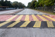 Speed bump or road hump in yellow and black stripe to slow down vehicles and promote road safety