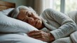 Elderly woman sleeping on a cozy white bed from Generative AI
