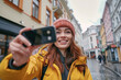 A young social media influencer travel blogger with a camera in an urban city