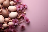 Fototapeta Kwiaty - Pastel easter eggs on soft pink background, surrounded by flowers, top view, copy space