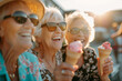 © MNStudio - Group of cheerful elderly female friends eating ice cream outdoors on sunny summer day. Senior ladies sharing a dessert in outdoor cafe.