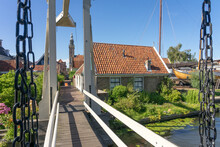Kwakelbrug Bridge In The Beautiful City Of Edam, Netherlands, With Its Typical Houses And The Church.