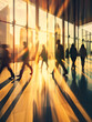 Defocused business people silhouette walking in large hallway with sun shining bright behind large corporate building windows